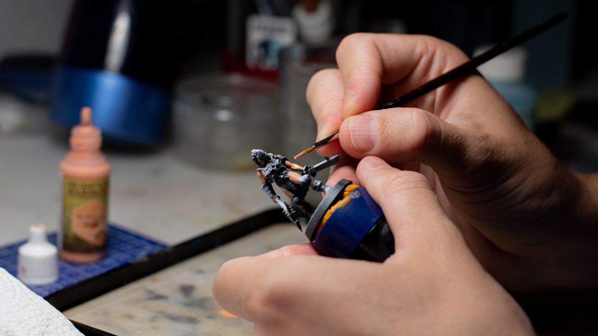 Hands paint a Dungeons and Dragons figurine