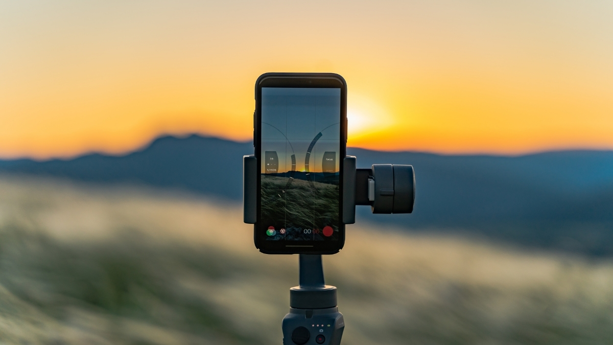 Smartphone set up in tripod taking photo of a sunset