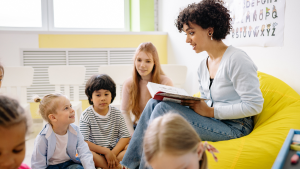 Woman reading book to children