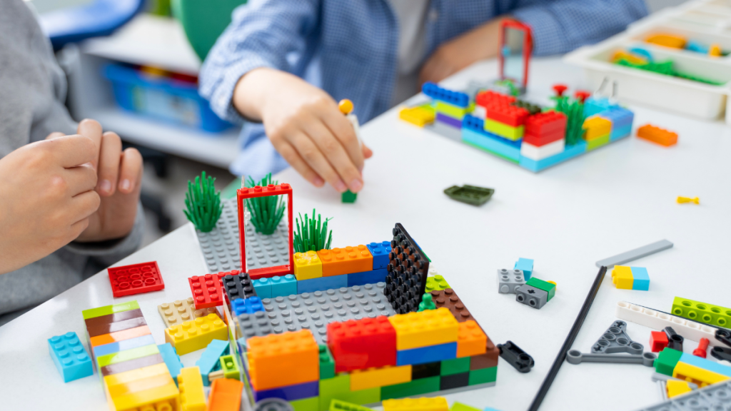 Kids building various structures with Legos