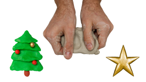 hands kneading clay into shape