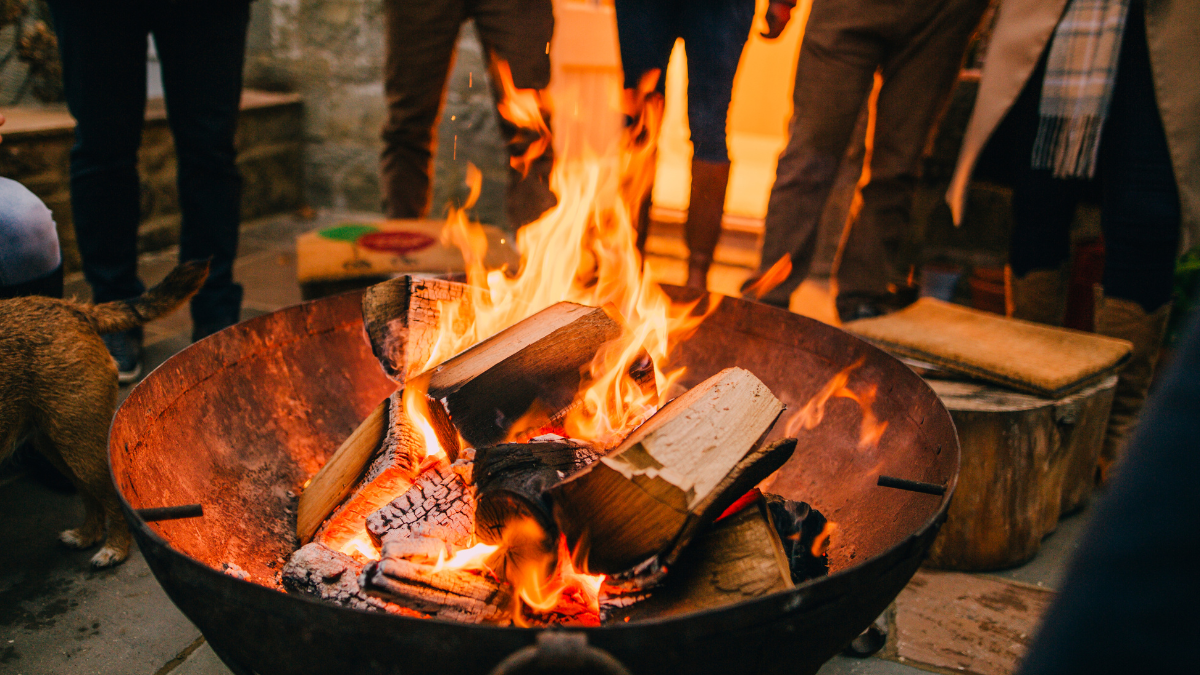 people standing around a campfire